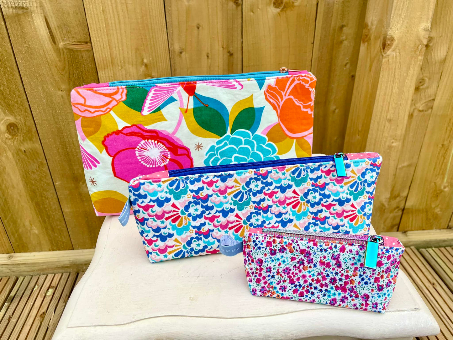 Set of colorful floral pouches on a wooden surface