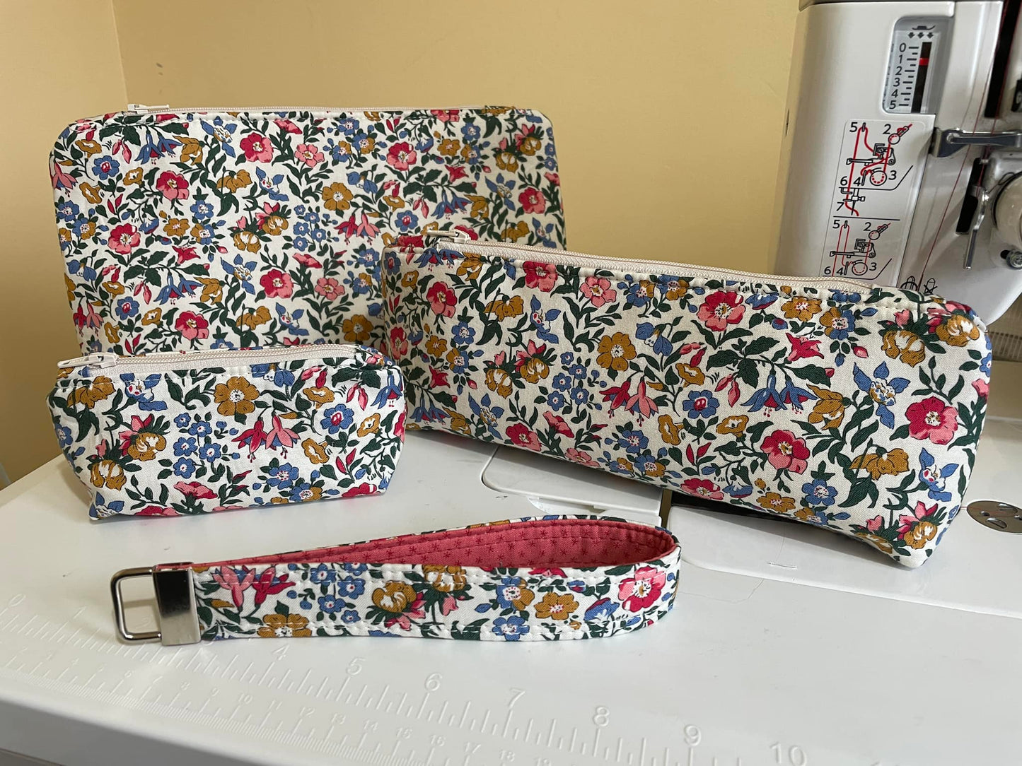 Floral-patterned fabric pouches on a sewing machine