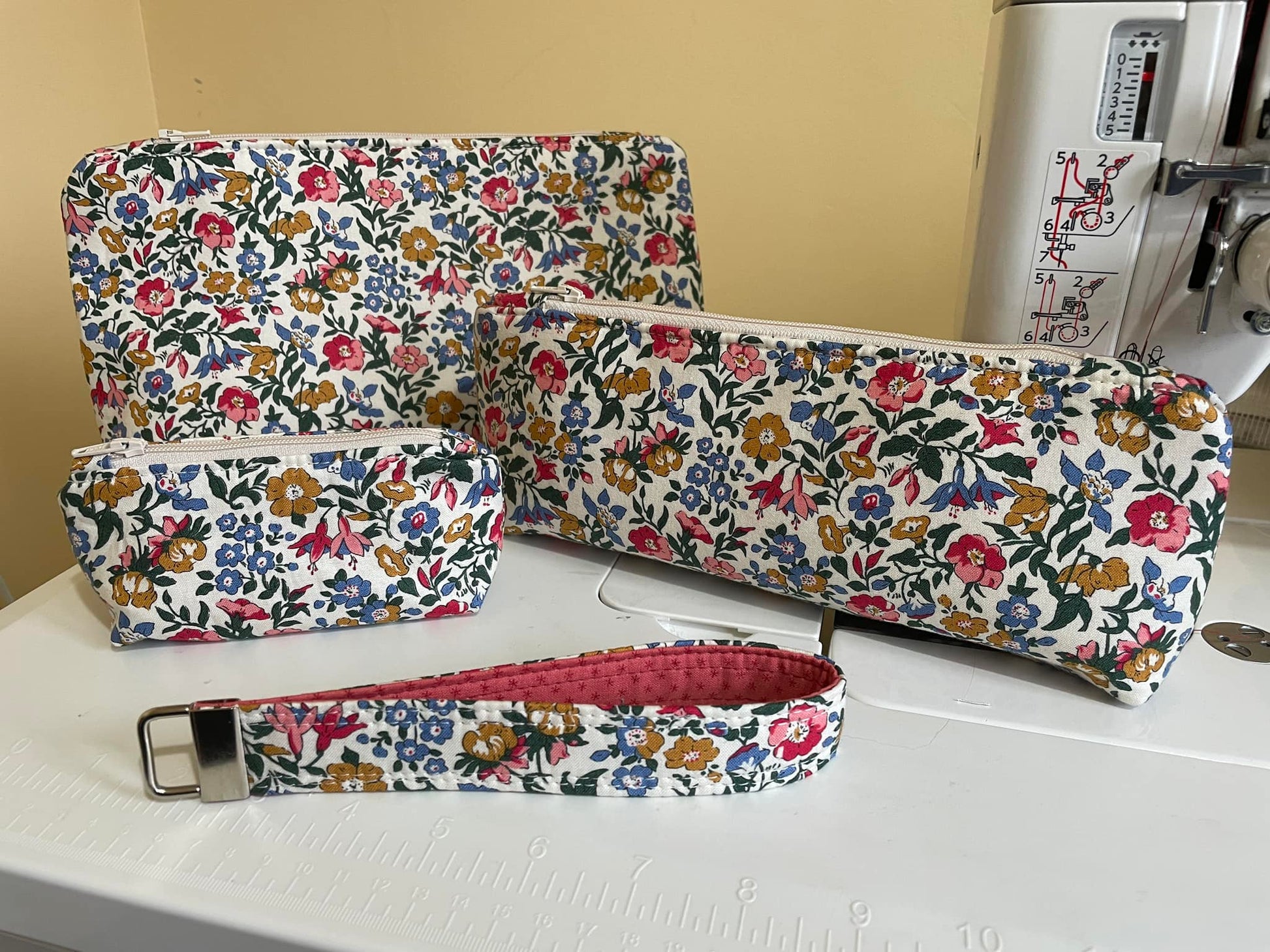 Floral-patterned fabric pouches on a sewing machine