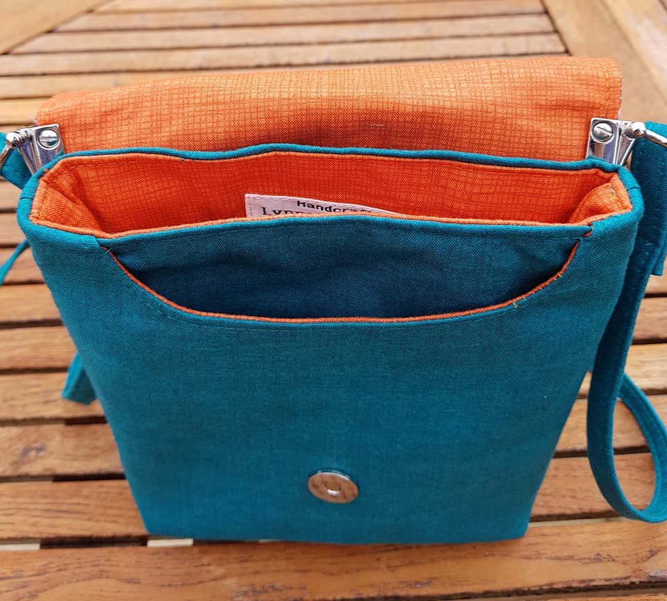 The Crossbody Bag PDF Sewing Pattern rear view with blue fabric with orange interior