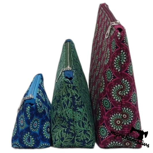 Three patterned bags in blue, green, and pink on a white background
