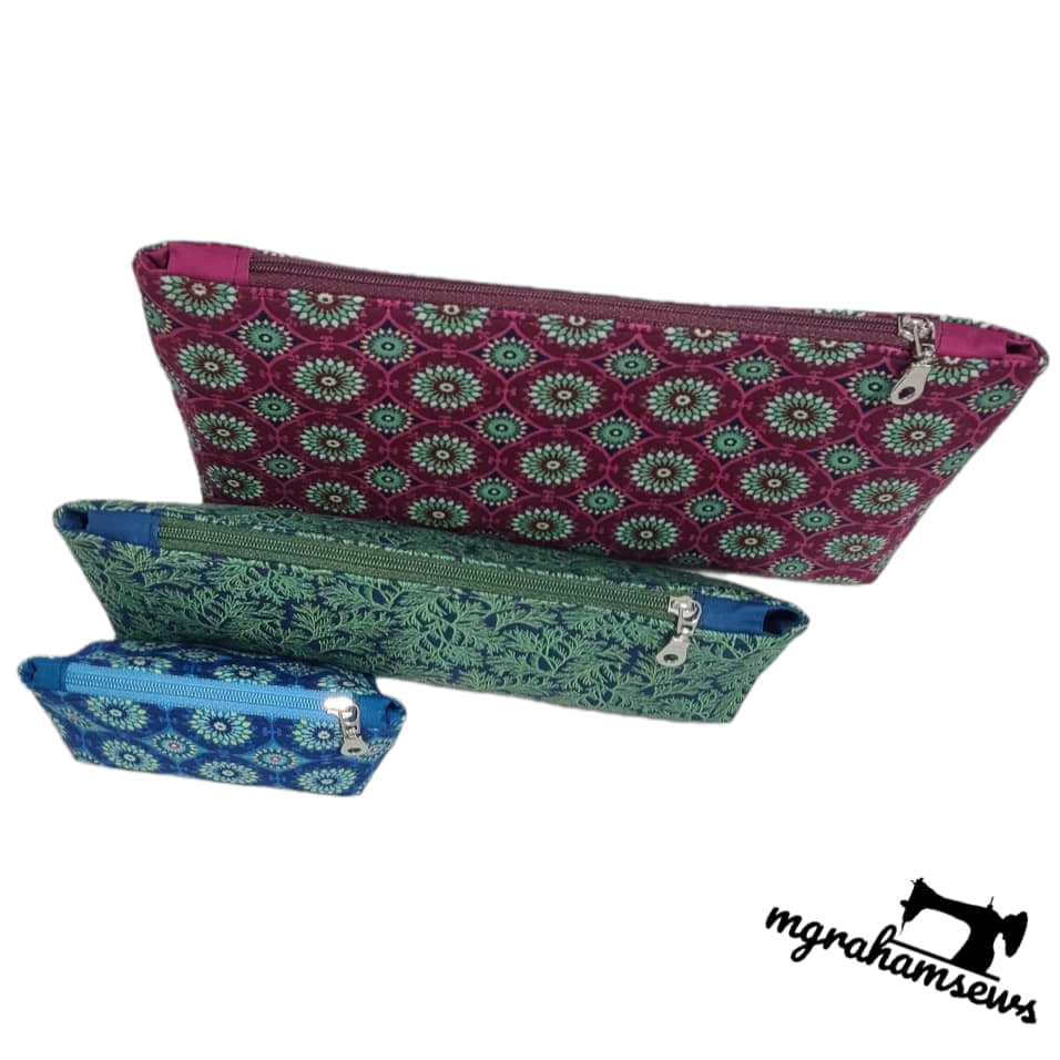 Three patterned pouches in purple, green, and blue on a white background with 'mghamsews' branding.