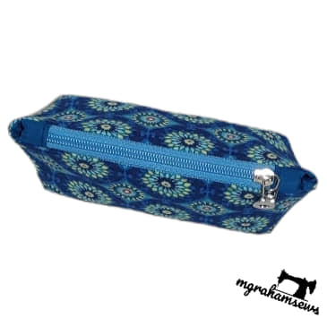Blue floral-patterned pencil case with a zipper on a white background