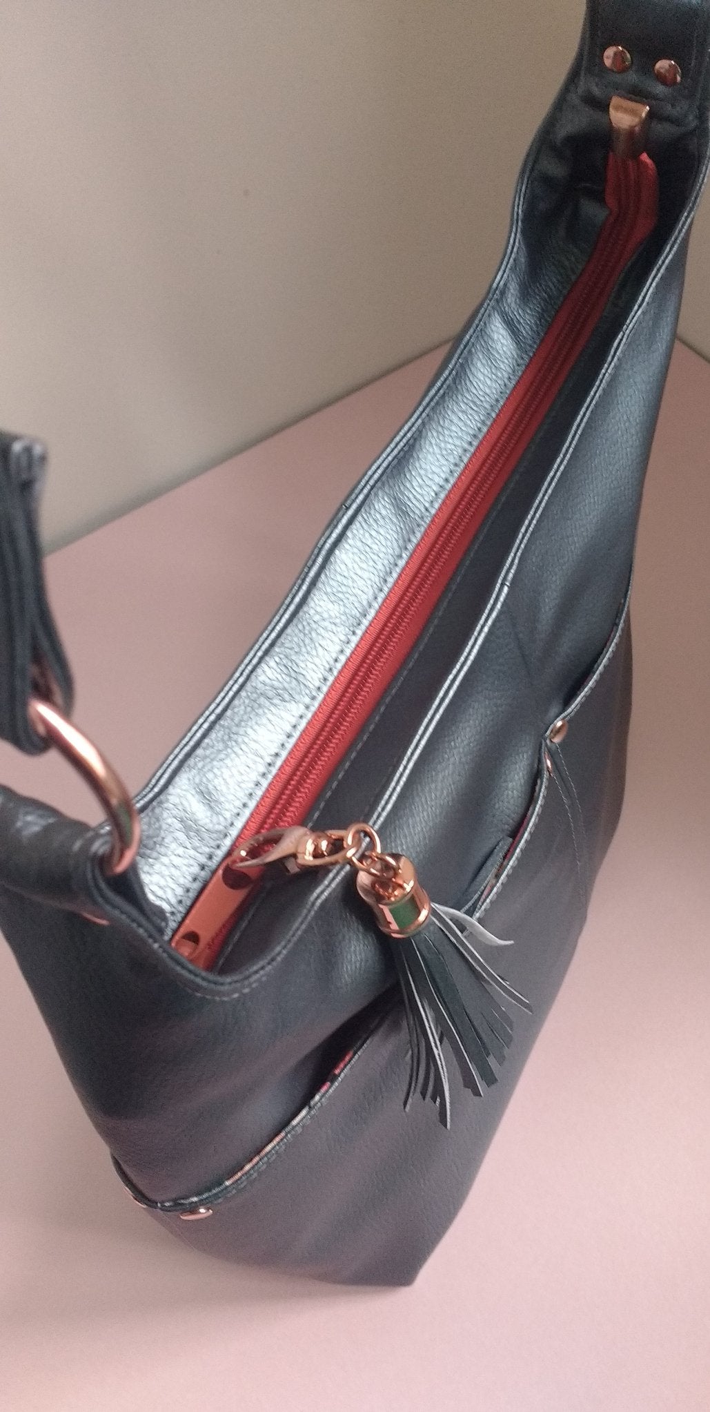 The Ring Sling PDF Sewing Pattern black with tassel with floral interior, top view